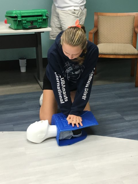 Diana performs CPR.
